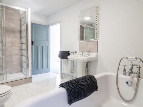a bathroom with a tub and a sink and a toilet at Mill View Duplex in Mansfield