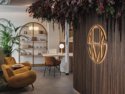 a room with a table and chairs and a table and a ceiling at Seven Hotel Paris in Paris