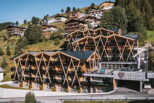 a large building on top of a mountain at GLEMM by AvenidA Superior Hotel & Residences in Saalbach Hinterglemm