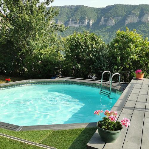 une piscine avec vue sur les montagnes dans l'établissement lesoleilo, à Mostuéjouls