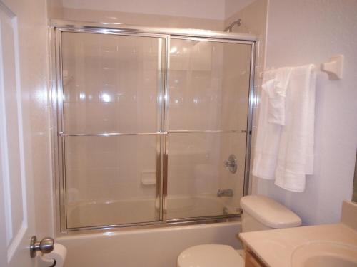 a bathroom with a shower with a toilet and a sink at Four Bedroom Townhouse in Regal Oaks at Old Town in Orlando