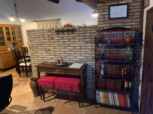 a room with a book shelf filled with dvds at Casa Rural Los Robles de Acebo II in Acebo