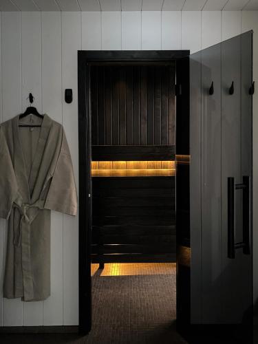 a coat hanging on a door in a room at Ragnar Glamp Pitrags Lux PREMIUM in Pitragutsiyeme