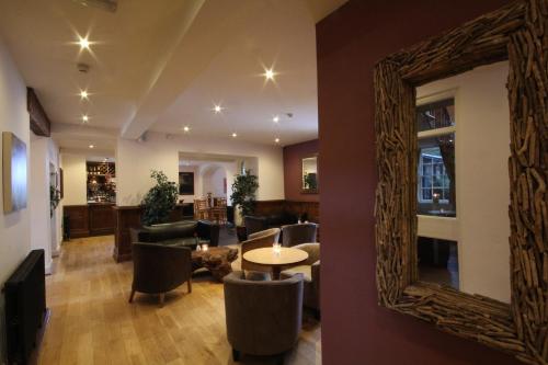 a mirror on the wall of a living room at Aberdunant Hall in Porthmadog