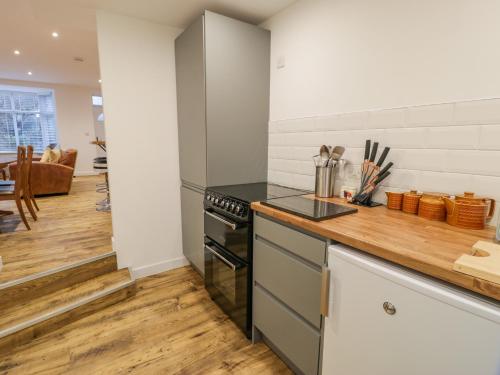 a kitchen with a stove and a counter top at Bronwen House in Llanbedr