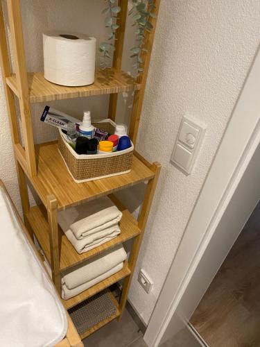 - une étagère avec des serviettes et du papier toilette dans la chambre dans l'établissement Ferienwohnung Westerwald-Domizil, 