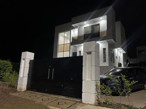a black car parked in front of a house at night at Villa Nila in Carmen de Apicalá