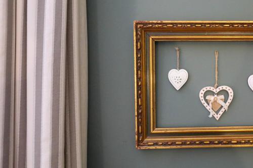 a picture of hearts in a frame on a wall at The Black Swan in Ravenstonedale