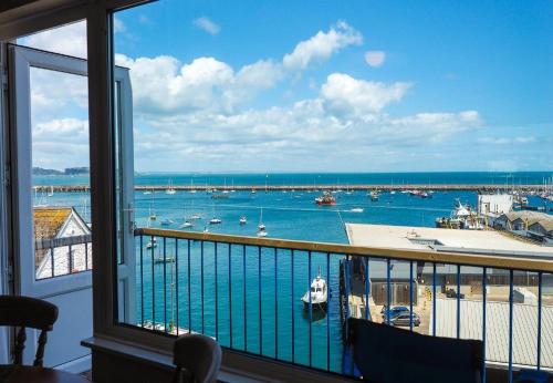 a view of a harbor from a room with a window at 8 Dolphin Court in Brixham