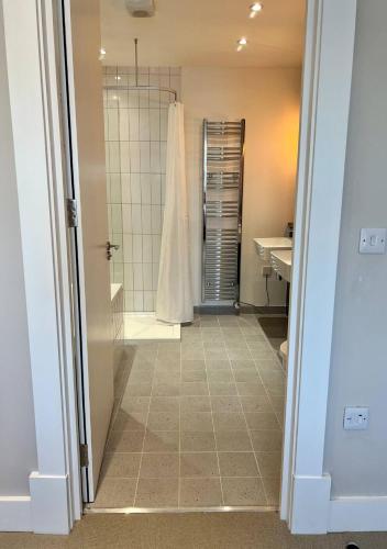 a bathroom with a shower and a sink at Margate Beach Front Apt With Sea Views Sleeps 6 in Kent