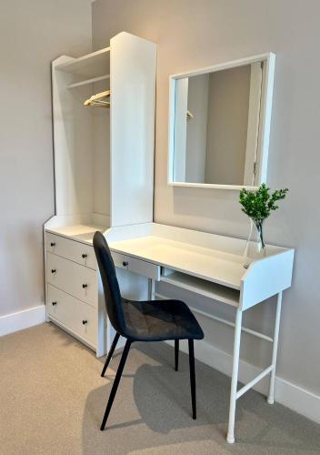 a white desk with a chair and a mirror at Margate Beach Front Apt With Sea Views Sleeps 6 in Kent