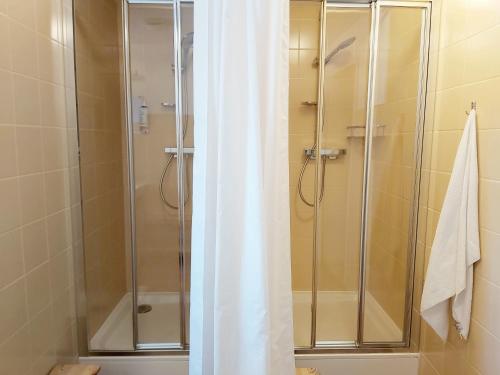 a shower with a glass door in a bathroom at Prezidentská in Bedřichov