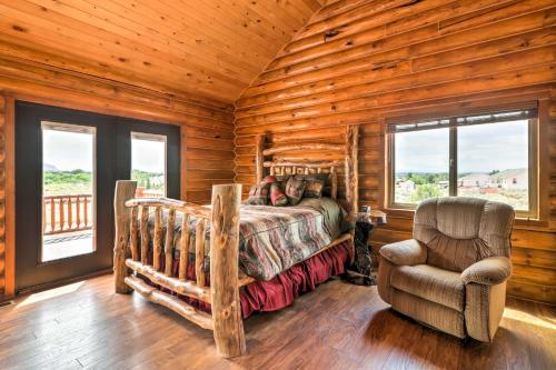 a bedroom with a bed and a chair in a log cabin at Dreamy Kanab Cabin with Hot Tub and Panoramic Views! in Kanab