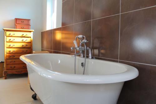 a bath tub with a faucet in a bathroom at Inglewood in Chorley