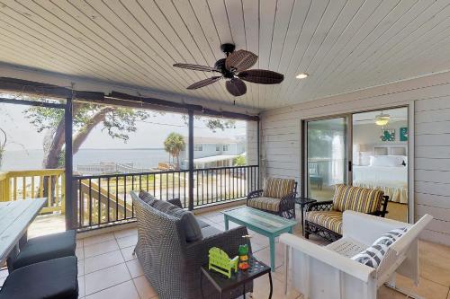 a screened in porch with a view of the ocean at After Dune Delight - 626 Beachview Drive in Saint Simons