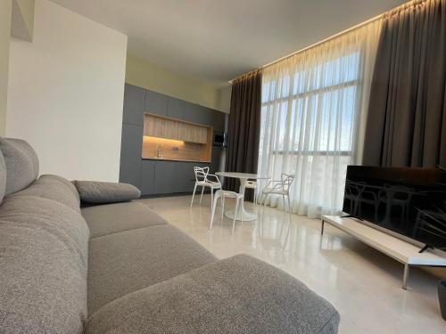 a living room with a couch and a table at Aljama Burgos in Burgos