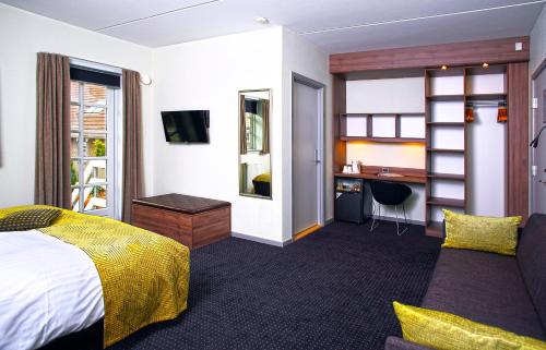 a hotel room with a bed and a desk at The Lodge Billund in Billund