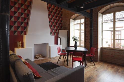 a living room with a couch and a table at Carlota Sustainable Design Hotel in Quito