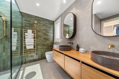 a bathroom with a sink and a mirror at Lavish at the Lake in Taupo