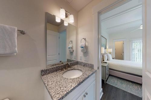 a bathroom with a sink and a bedroom with a bed at King Suite @ 400 Ocean Suites in King City