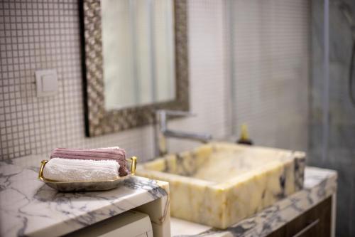 a bathroom with a sink and a counter top at Maison d' Alice 1 in Tríkala