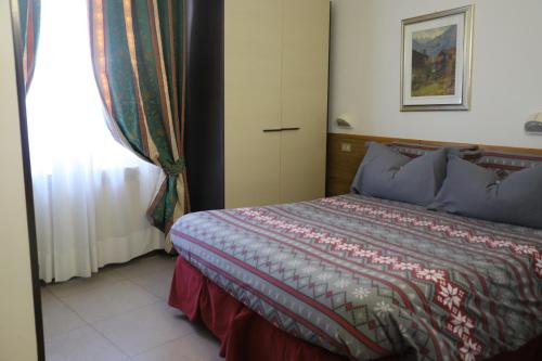 a bedroom with a bed and a window at Hotel Bucaneve in Pré-Saint-Didier
