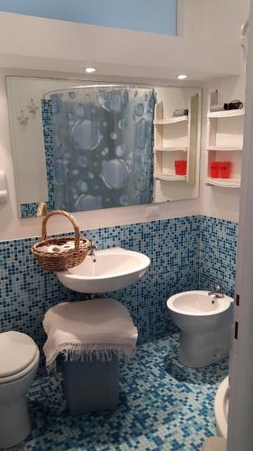 a bathroom with a sink and a toilet and a sink at La Casa Sul Lago in Salò