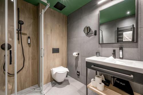 a bathroom with a toilet and a sink and a shower at The Moss - Your unique hideaway in Obergurgl