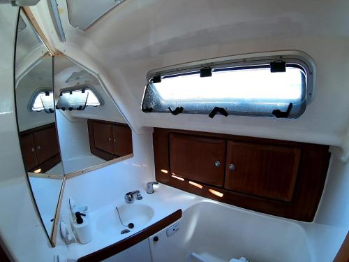 a bathroom with a mirror and a sink and a window at Magnifico barco en La Graciosa in Caleta de Sebo