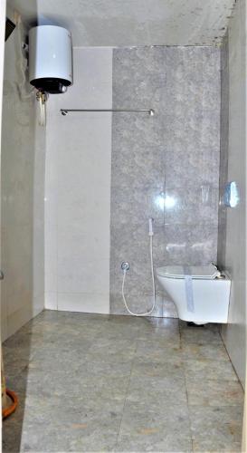 a bathroom with a sink and a toilet in a room at Srirathna Temple View Inn in Thanjāvūr