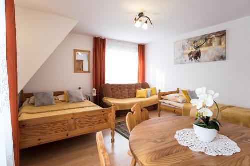 a living room with two beds and a couch at Zakopane - Harenda 13e in Zakopane