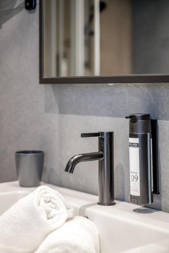 a bathroom sink with a faucet and a towel at The Moss - Your unique hideaway in Obergurgl