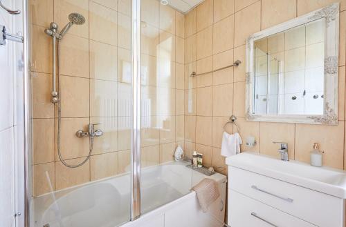 a bathroom with a shower and a tub and a sink at Kurpių gatvė in Kaunas