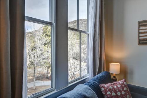 a room with a large window with a couch and a lamp at South Main Residences by Surf Hotel in Buena Vista