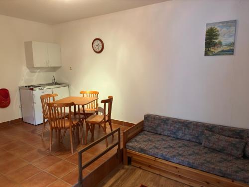 a living room with a couch and a table with chairs at HAnd Birtok in Siklós