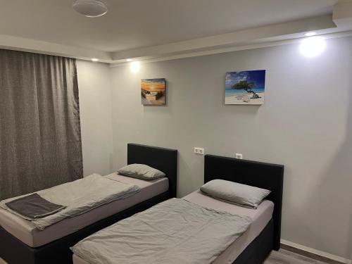 two beds in a small room with two at Apartment Home in NRW in Gladbeck