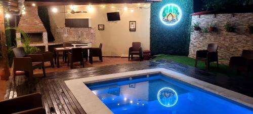 a swimming pool in a living room with a bar at Casa 24 Puerto Iguazu in Puerto Iguazú