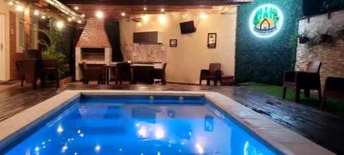 a swimming pool in a patio with a table and chairs at Casa 24 Puerto Iguazu in Puerto Iguazú