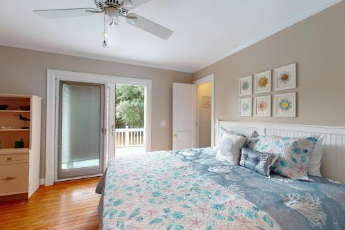 a bedroom with a bed and a ceiling fan at 44 Dune House - 1901 Dixon Lane in Saint Simons Island
