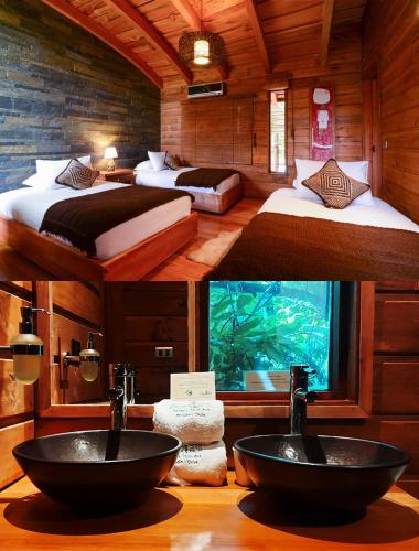 a bathroom with two sinks in a room with an aquarium at Aldea Naukana Posada Boutique in Pucón
