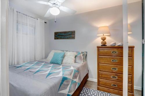 ein Schlafzimmer mit einem Bett und einer Kommode in der Unterkunft EZBreezy - 4217 Fifth Street in Saint Simons Island