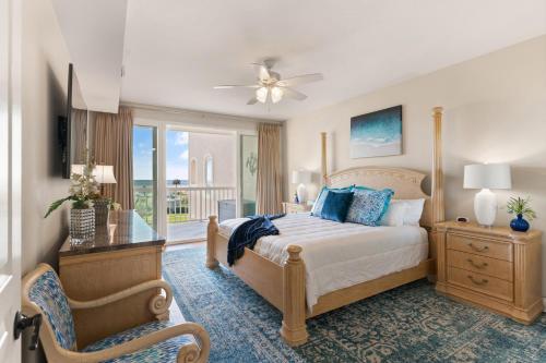 a bedroom with a bed and a chair and a window at St Simons Grand 216 - Ocean Blvd in East End