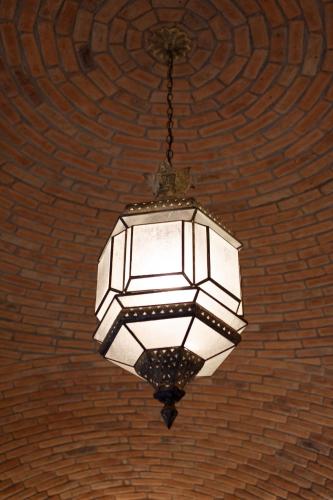 a large light hanging from a brick ceiling at Casa 1810 Hotel Boutique in San Miguel de Allende