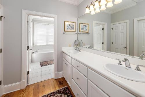 a white bathroom with two sinks and a tub at Satilla Cottage - 15 Coast Cottage Ln in East End