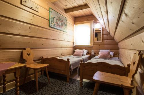 a room with two beds in a log cabin at Zakopane - Harenda 13e in Zakopane