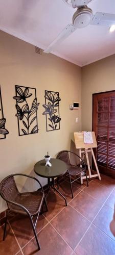 a room with two tables and chairs and a table at Casa 24 Puerto Iguazu in Puerto Iguazú
