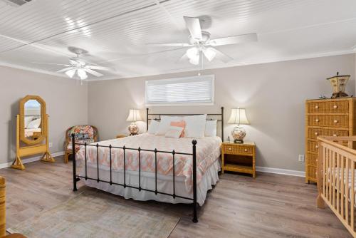 ein Schlafzimmer mit einem Bett und einem Deckenventilator in der Unterkunft Byrd's Nest - 1107 Beachview Drive in Demere Park