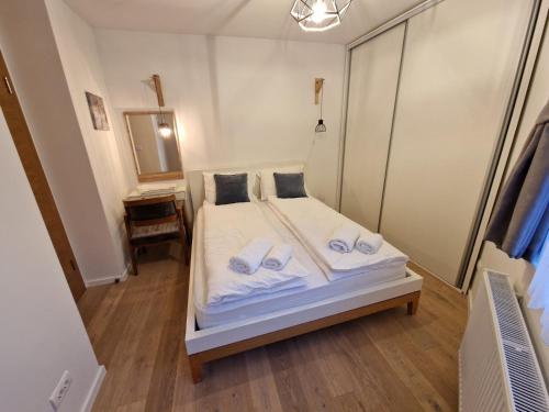 a bedroom with a bed with towels on it at Olimpijska kuća A307 in Jahorina