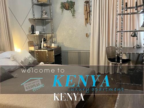 a bedroom with a bed and a sign that says welcome to kennya twenty at Global Home - Aparthotel - No Contact Check In in Mielec
