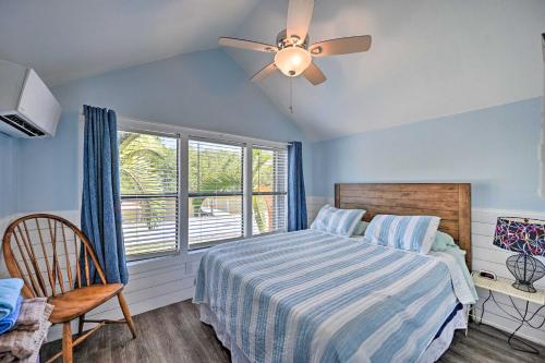 a bedroom with a bed with a ceiling fan and a window at Everglades City Cabin Dock and Heated Pool! in Everglades City